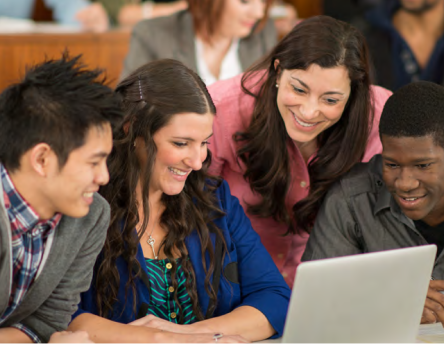 A group of people looking at a laptop screen